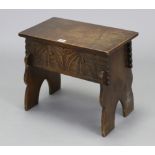 An oak box-seat stool with hinged lift-lid, carved front & with shaped end supports, 17¼” wide x 15”