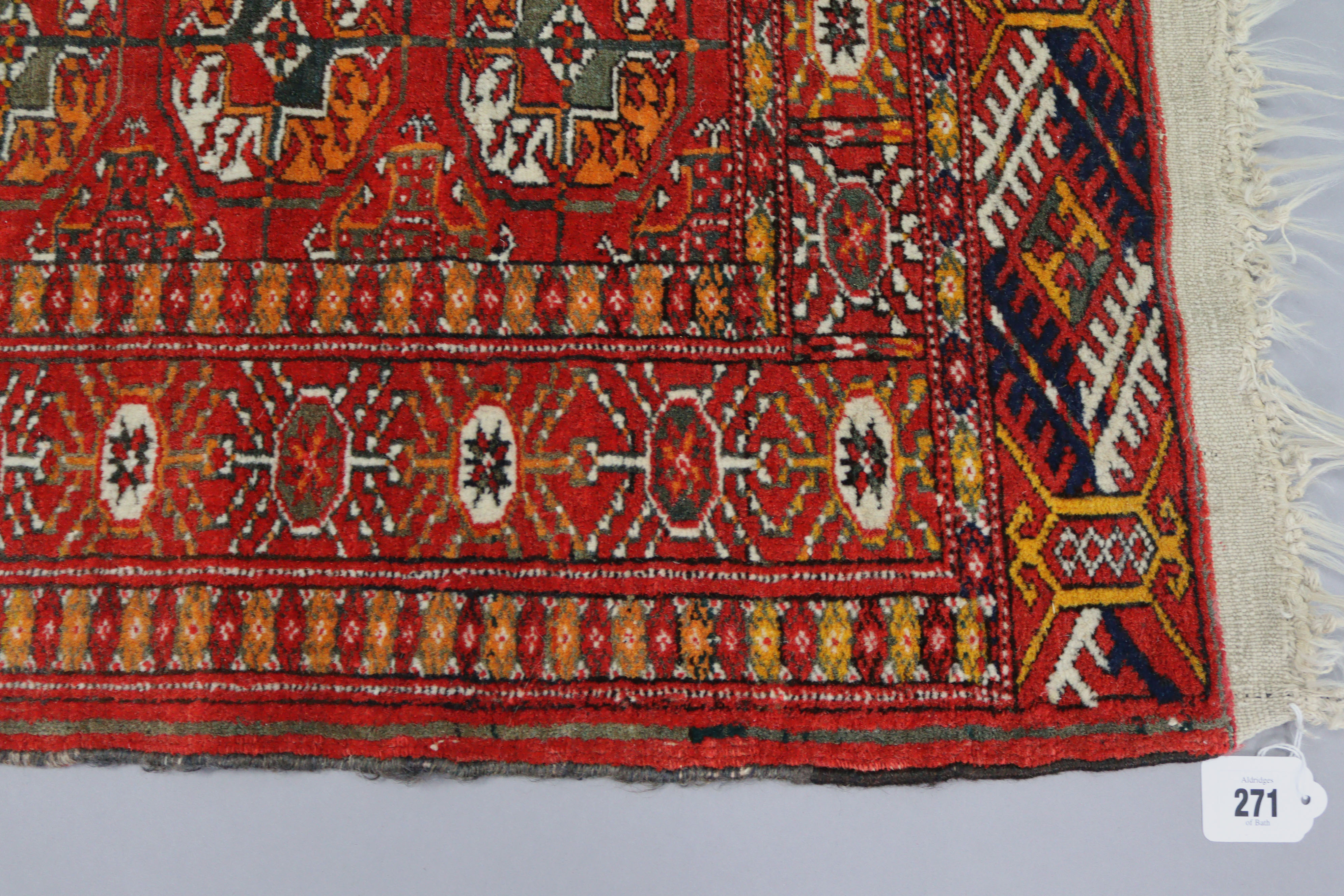 A Bokhara rug of crimson & ivory ground with three rows of guhls to centre within a wide border, 60” - Image 2 of 4