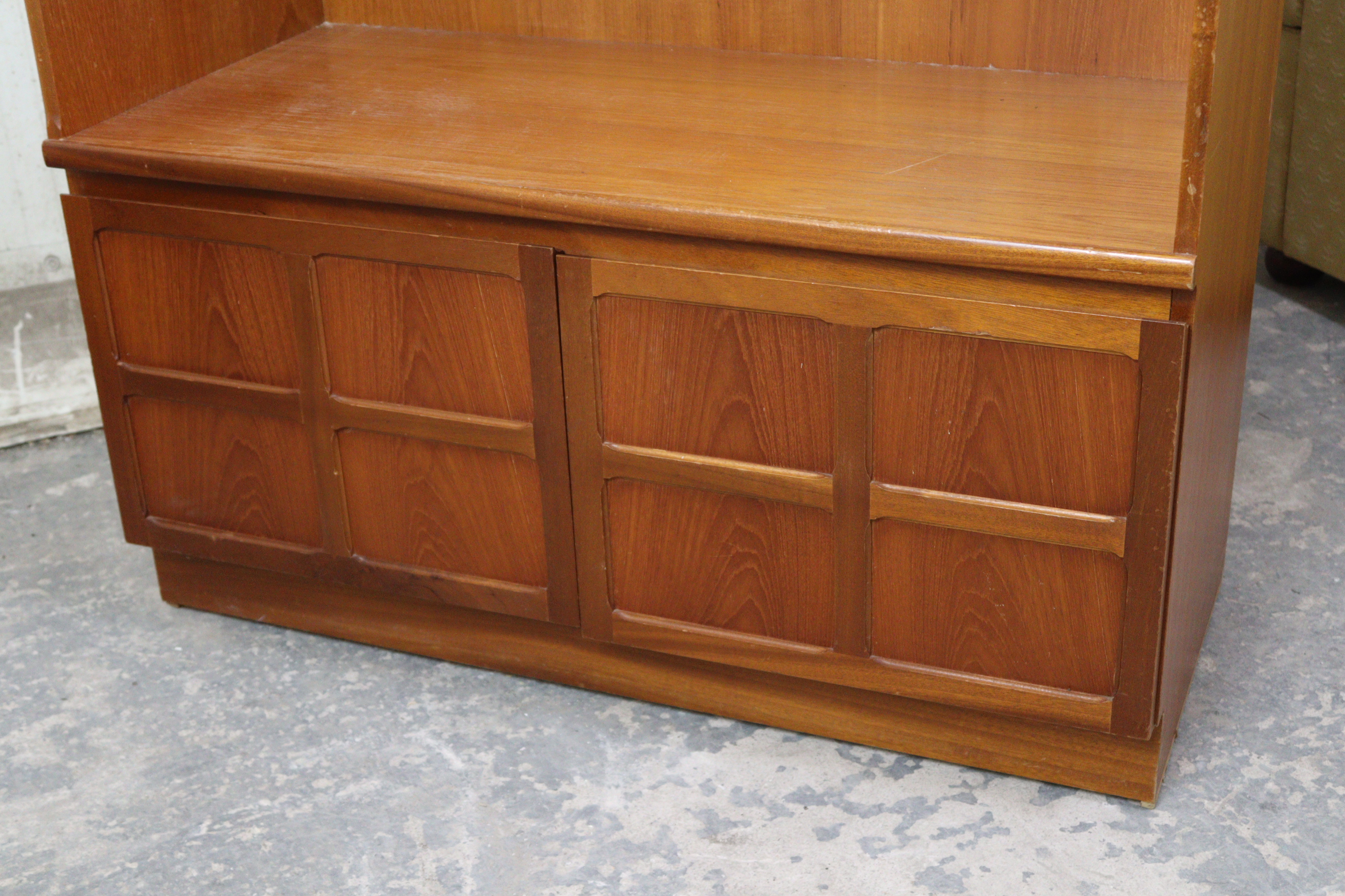 A Nathan teak tall wall unit fitted two shelves above cupboard enclosed by a pair of panel doors, - Image 2 of 4