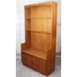 A Nathan teak tall wall unit fitted two shelves above cupboard enclosed by a pair of panel doors,