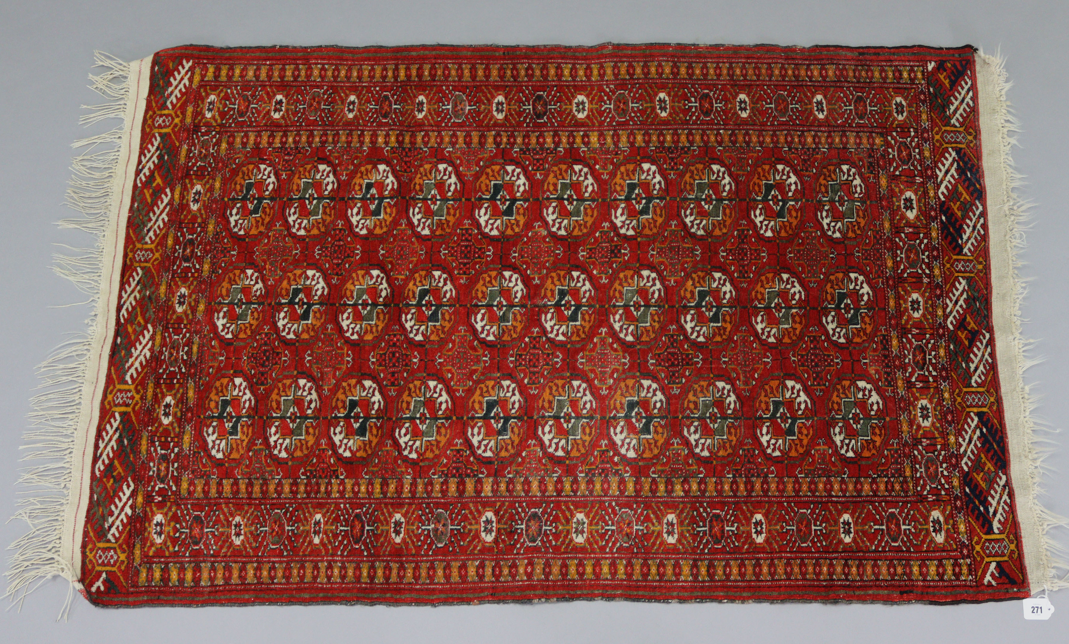 A Bokhara rug of crimson & ivory ground with three rows of guhls to centre within a wide border, 60”