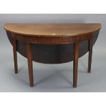An early 20th century mahogany circular single-drop leaf dining table on four square tapered legs,
