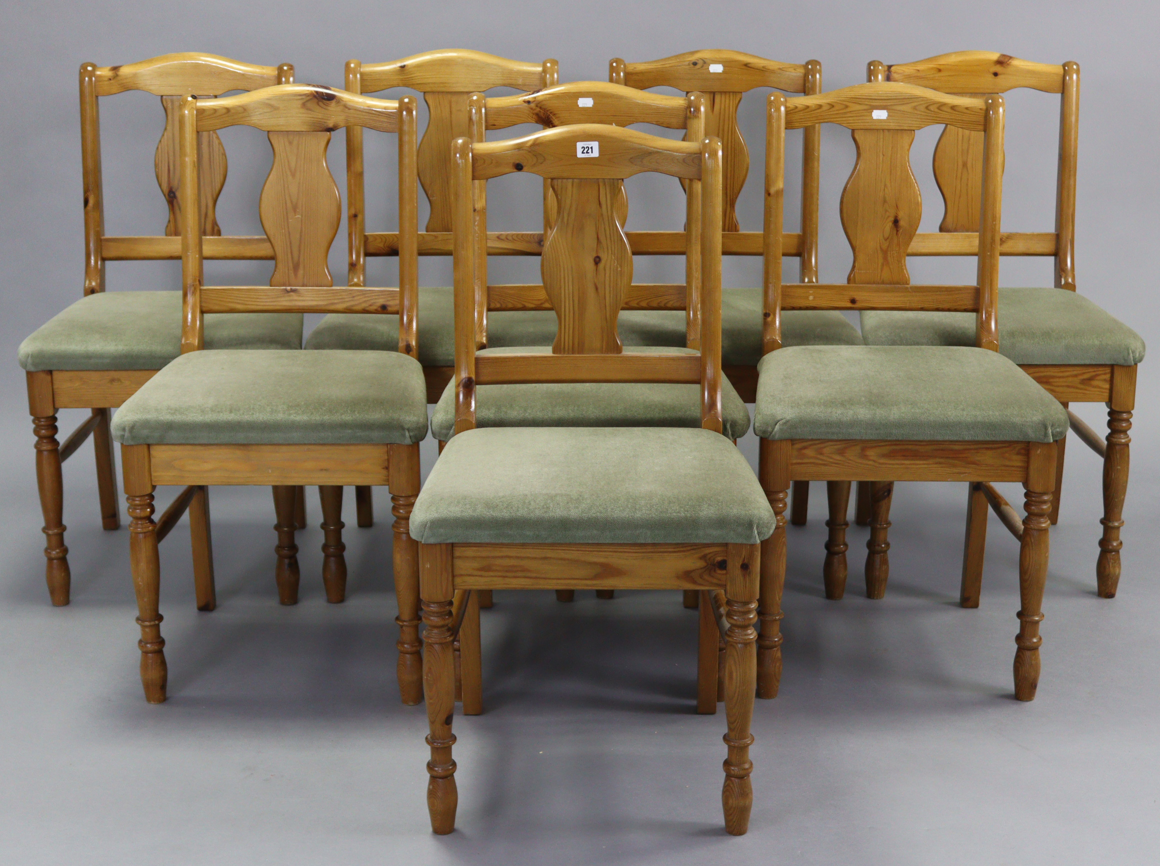 A set of eight Ducal pine splat-back dining chairs with padded seats, & on turned legs with