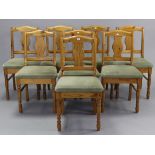 A set of eight Ducal pine splat-back dining chairs with padded seats, & on turned legs with