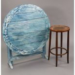 A continental-style pale blue painted wooden kitchen table with circular tilt-top, & on square legs,