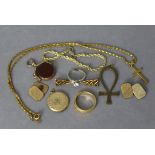 A yellow-metal necklace with crucifix pendant; a ditto circular photograph locket; a ditto ring; &