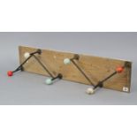 Two sets of three vintage coat hooks mounted on a wooden board, 35½” x 7¾”.