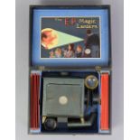 A late 19th/early 20th century “The E.P.” standard magic lantern projector set, with seventeen