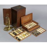 A brass monocular student’s microscope, 9¾” high, cased; & a case containing numerous microscope