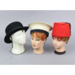 A Dunn & Co of London black felt bowler hat; together with sailor’s hat; a fez; & three milliner’s