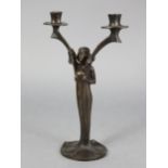 A reproduction bronzed cast-metal twin-branch table candelabra, the centre column in the form of a