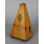A Maezel metronome in mahogany case, 9” high.