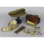 A British military officer’s peak cap; nine various cap badges; two belts, etc.