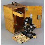 A Bausch & Lomb black lacquered monocular microscope (VK9615), 12½” high, with mahogany case.