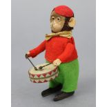 An early 20th century Schuco cloth-covered tinplate automaton monkey drummer character figure, 4½”