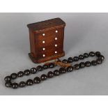 A nut-shell necklace, 33” long; & a wooden novelty “chest” money box, 5½” wide x 6” high.