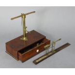 An early 20th century brass portable beam scale, fitted long drawer to the mahogany box base; &