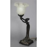 A vintage simulated bronze figural table lamp in the Art Nouveau style with frosted glass shade;