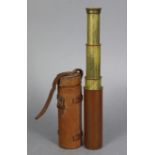 A Dollonds of London brass three-draw telescope with leather-covered tube, 16¾” long with leather