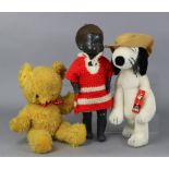 A 1950’s Pedigree black celluloid walking doll, 21” tall, dressed; a 1970’s “Spike” (Snoopy’s