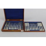 A set of twelve pairs of steel dinner knives & forks with silver-plated stylised handles, & in a