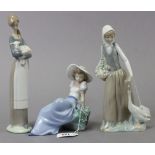 A Lladro Nao porcelain ornament in the form of a seated female figure with a bird by her side, 6¼”