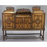 A 1930’s carved oak aesthetic-style sideboard fitted two long drawers to centre with moulded