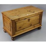 A pine blanket box with hinged lift-lid, fielded panel sides & on bun feet, 34” wide x 20” high.