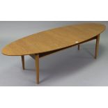 An Ikea “Stockholm” low coffee table with elongated oval top, & on four round tapered legs with open