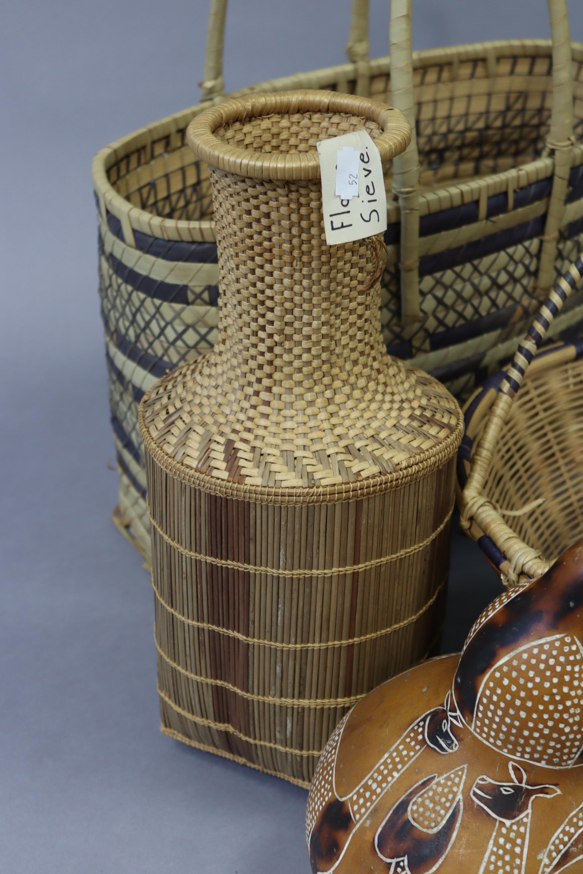 A Japanese-style metal table lamp; an Aboriginal gourd vessel, various similar wicker baskets & bow - Image 4 of 5