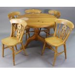 A pine pedestal dining table, with circular tilt-top & on vase-turned centre column & three cabriole