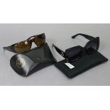 A pair of Gucci sunglasses; & a pair of Ray-Ban sunglasses, each with case.