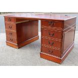 A reproduction yew wood pedestal desk fitted with an arrangement of four drawers & a cupboard, 60”