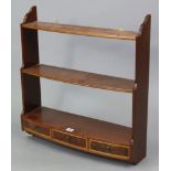 A set of reproduction mahogany bow-front wall shelves of three open tiers, fitted three small