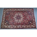 A Persian pattern small carpet with all-over multicoloured floral design, 8’ 5” x 5’ 4”.