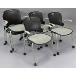 A set of six black & silvered plastic swivel office chairs.