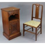 A late Victorian mahogany bedside cupboard, fitted frieze drawer above an open recess, with cupboard