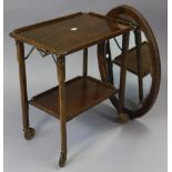 A 1930’s oak rectangular two-tier fold-away tea trolley, on octagonal legs with castors, 24” wide;