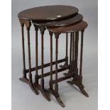 An Edwardian mahogany nest of three oval occasional tables, each table on pair of spider-turned legs