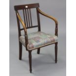 A 19th century mahogany bow-back carver chair with padded seat, & on turned tapered legs.