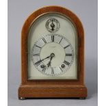 An early 20th century mantel clock, the silvered dial with roman numerals & signed “E. J. Yokes,