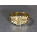 A late Victorian 18ct. gold ring set two small diamonds flanked by four pairs of seed pearls, a