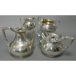 A VICTORIAN FOUR-PIECE TEA & COFFEE SERVICE of round semi-fluted form, with reeded angular handle,
