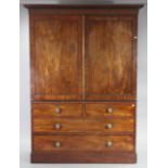 An early 19th century mahogany wardrobe with moulded cornice, a hanging compartment to the top secti