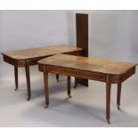 A George III inlaid mahogany extending dining table, having two D-shaped ends, with one additional