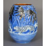 A Burleigh Ware ovoid vase with relief decoration of a procession of leopards in the jungle, in