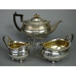 A regency silver matched three-piece tea service of oval form with silver-gilt interiors & gadrooned