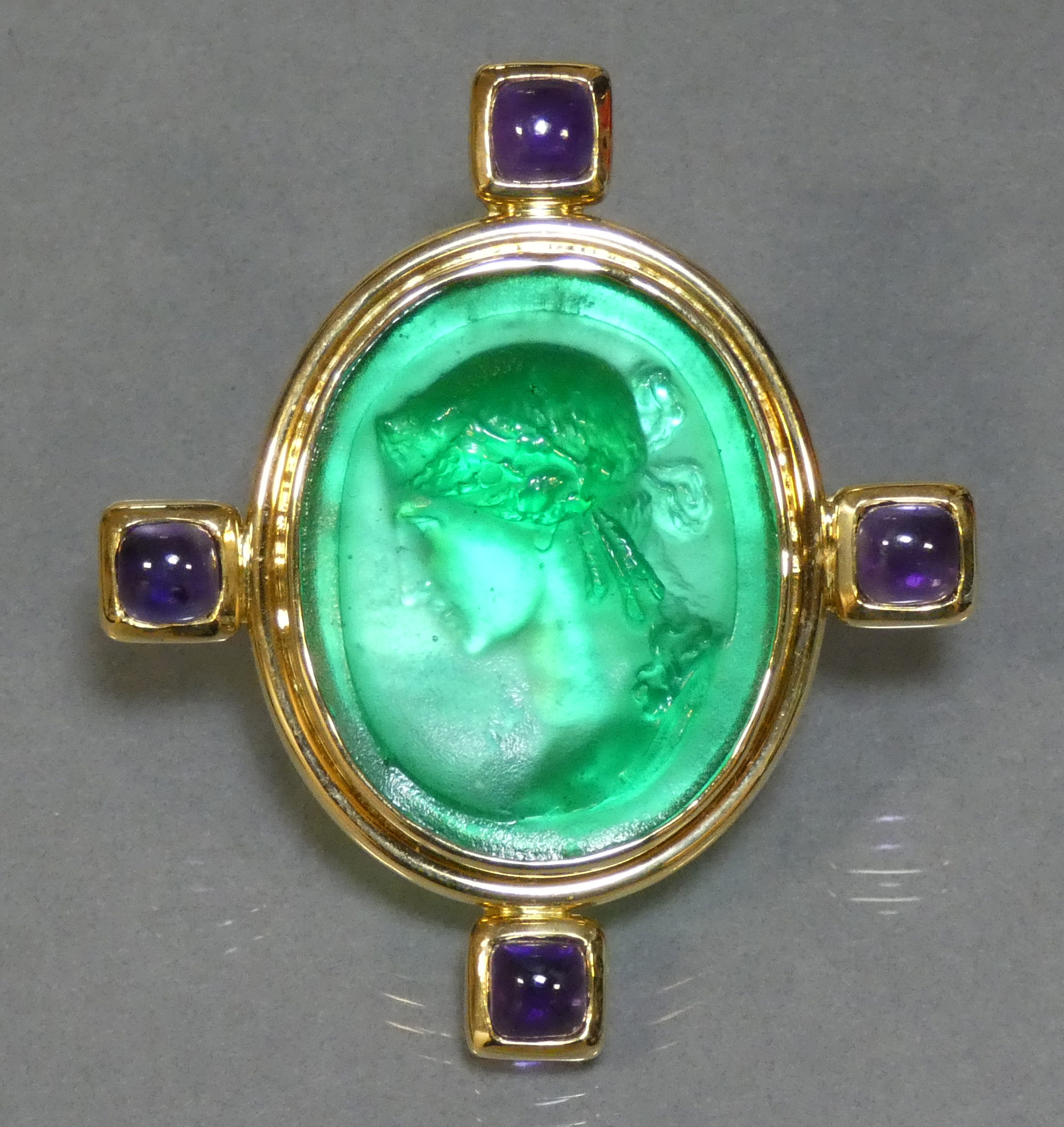 An Elizabeth Locke 18K brooch set oval Venetian green glass cameo of a classical female bust, four