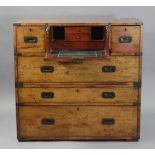 A MID-19TH century TEAK & BRASS-MOUNTED CAMPAIGN CHEST, fitted central secretaire drawer inset