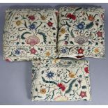 Three late 18th/early 19th century crewel-work scatter cushions of cream ground with all-over
